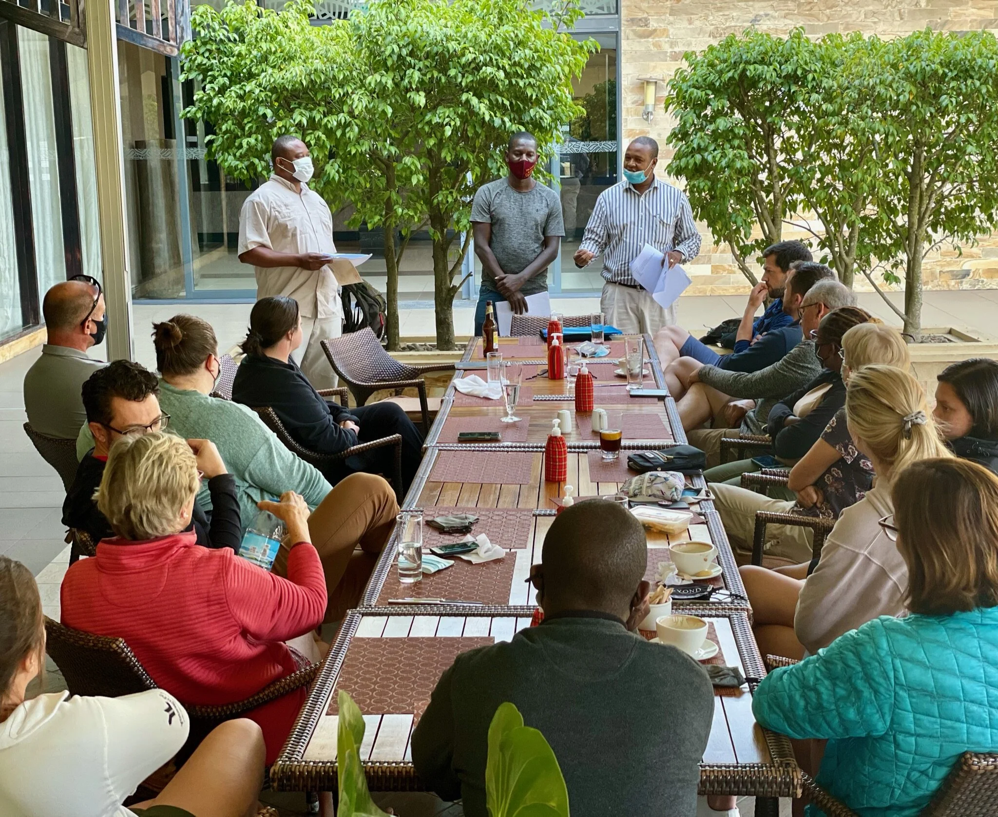 Kilimanjaro trekking briefing session with guides and climbers preparing equipment