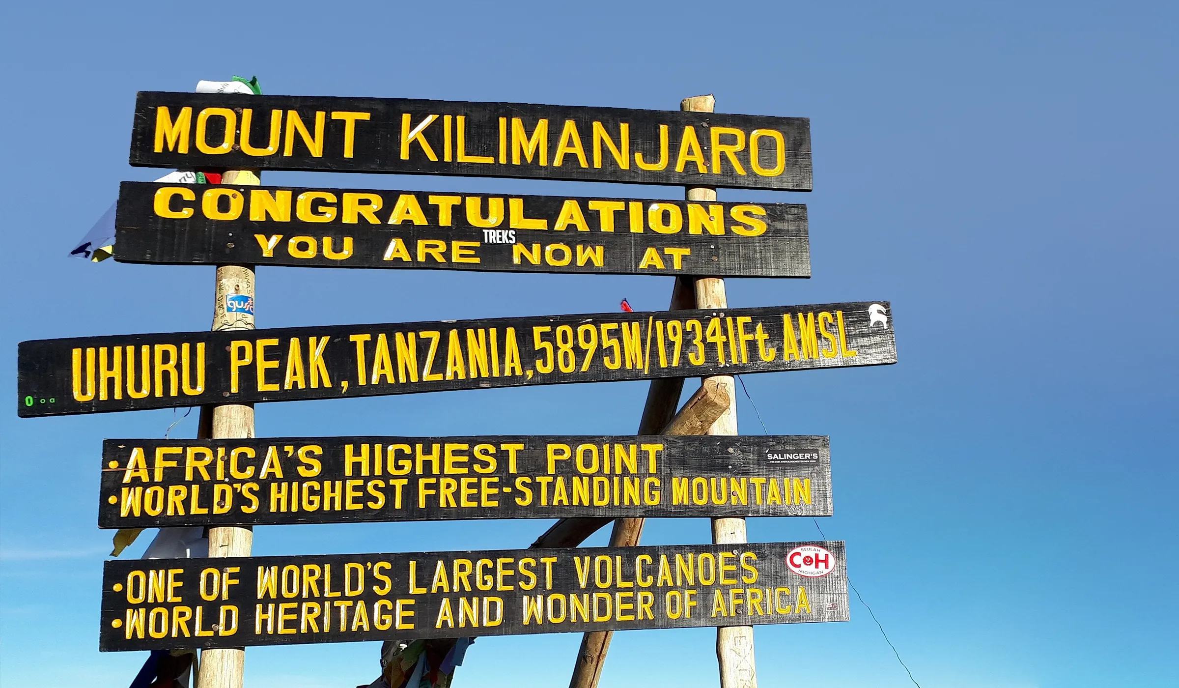 Climbers celebrating at Uhuru Peak summit on Mount Kilimanjaro during Lemosho Route trek